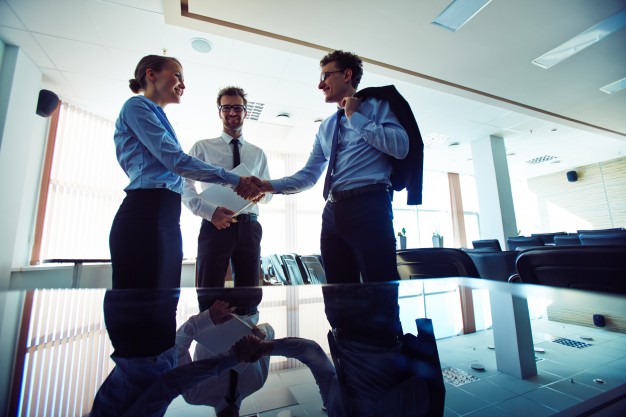 businesspeople-shaking-hands-at-workplace_1098-4112